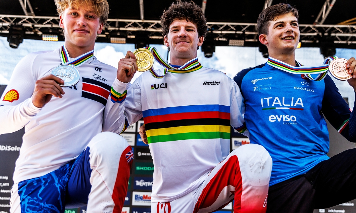 3 young man on a winners podium with medals