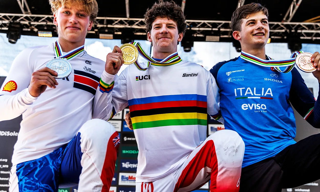 3 young man on a winners podium with medals