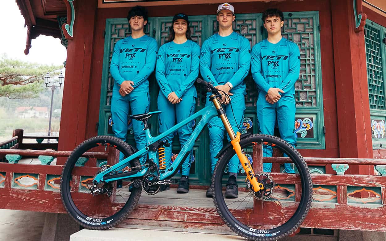 Pro mountain bike team with their race bike